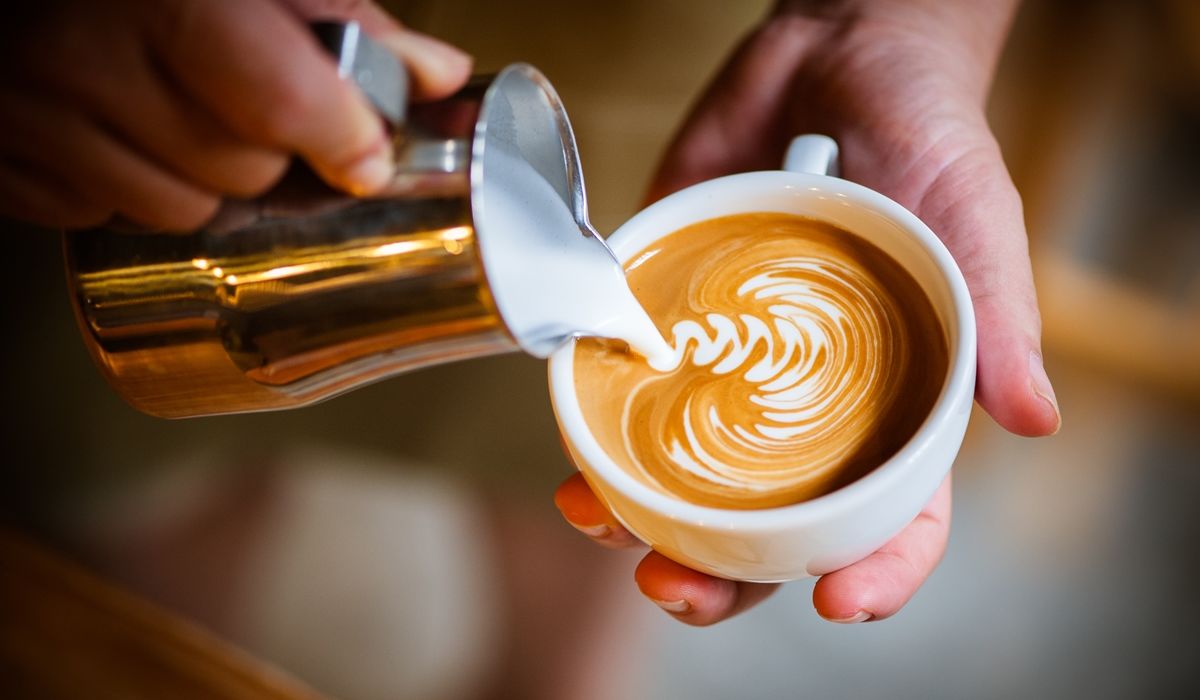 Image of coffee being poured with cream.