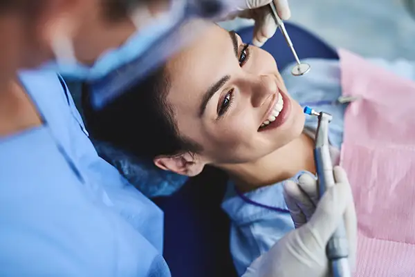 A woman smiling at crown consultation at Highridge Dental Care in Folsom, CA
